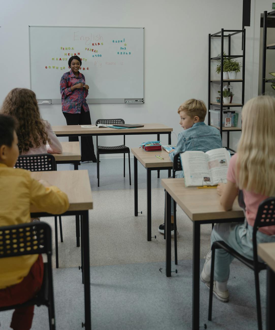 teacher standing in front of a whiteboard